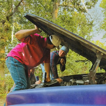 Men wearing vintage clothing together in a truck